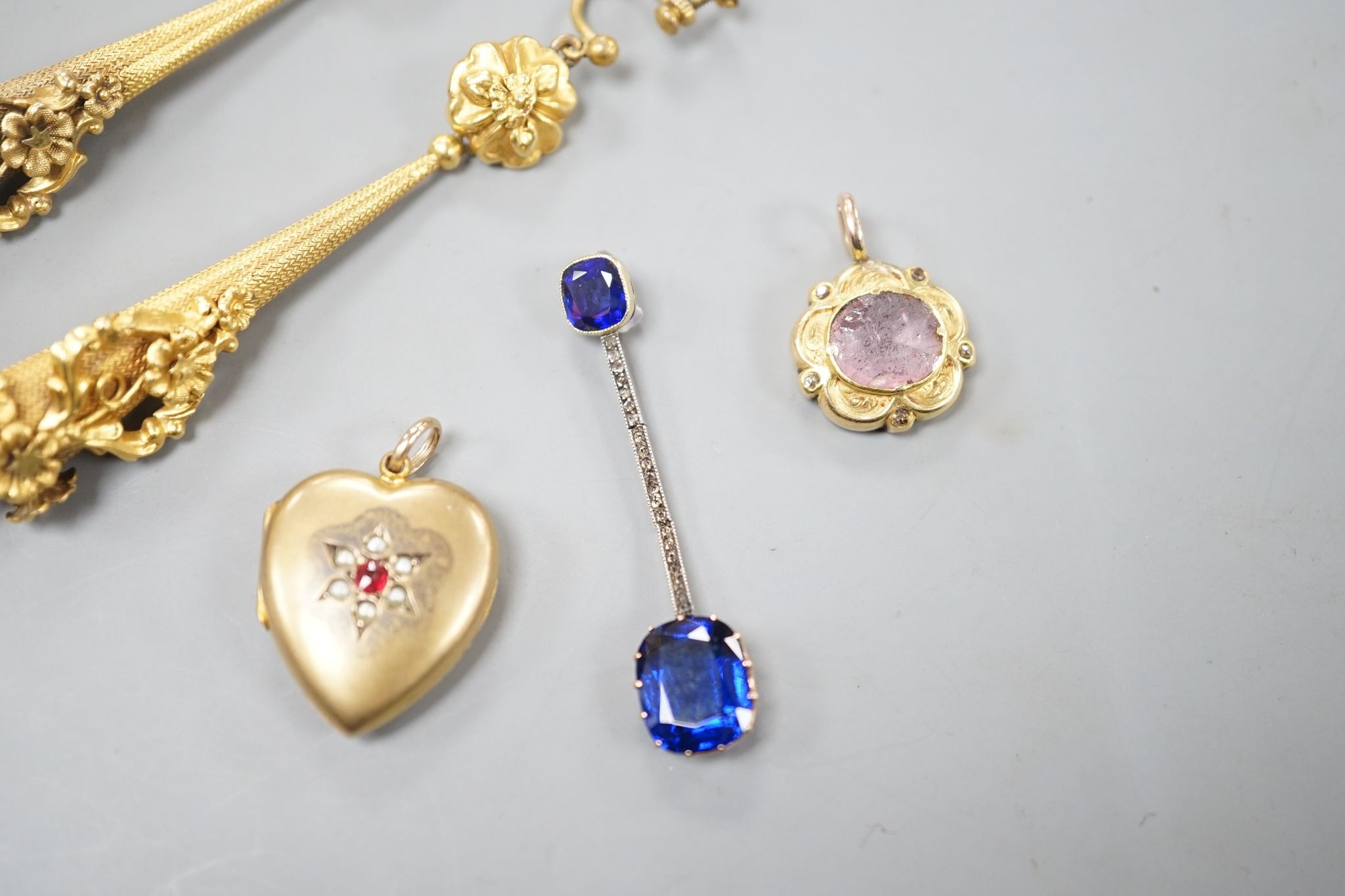 A pair of yellow metal drop earrings, overall 89mm, a simulated sapphire pendant and two other pendants.